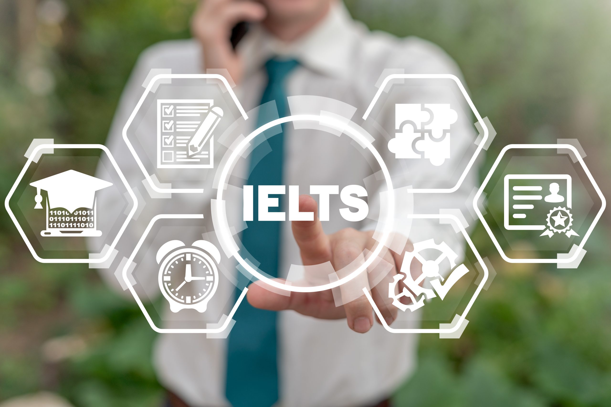 Man touches ielts acronym on virtual screen. IELTS International English Language Testing System. English test exam education concept.
