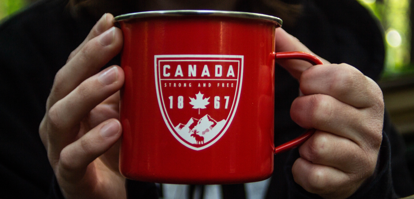 Person holding Canada labelled coffee mug